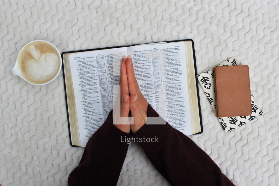 a woman reading a Bible and praying 