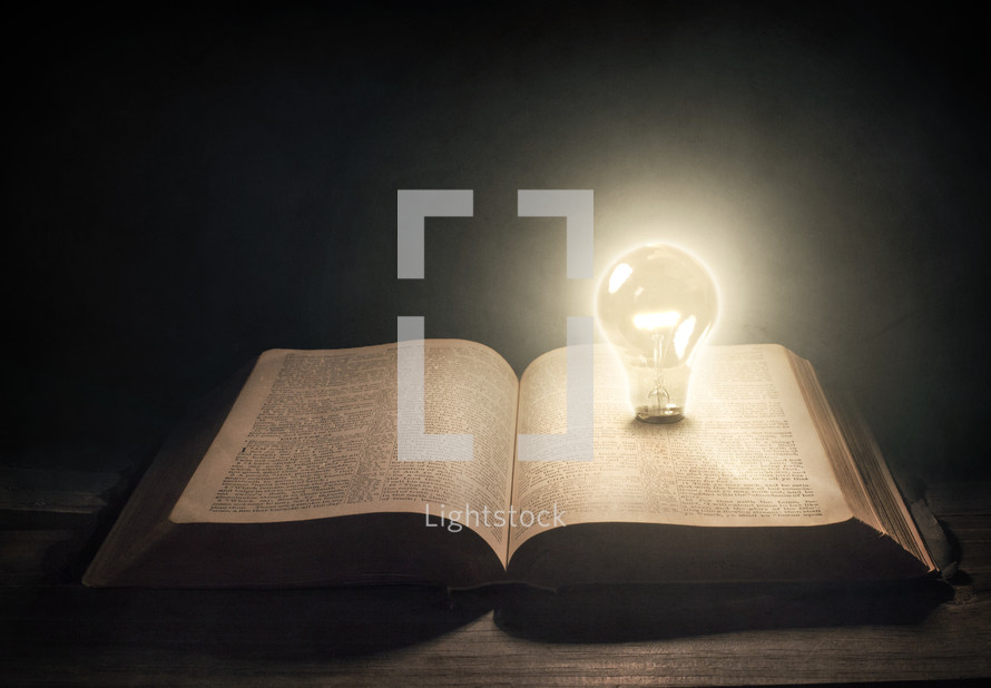 open Bible with lightbulb 