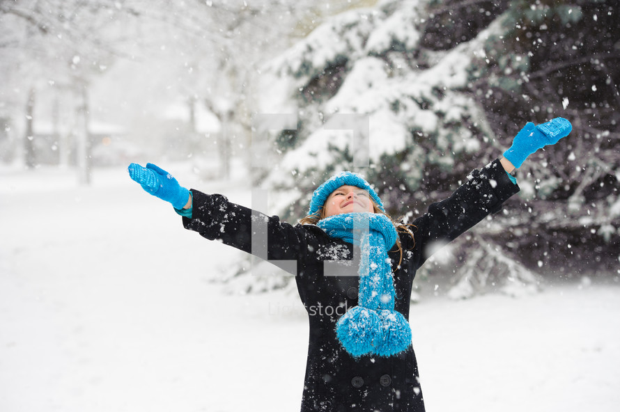 girl playing in the snow 
