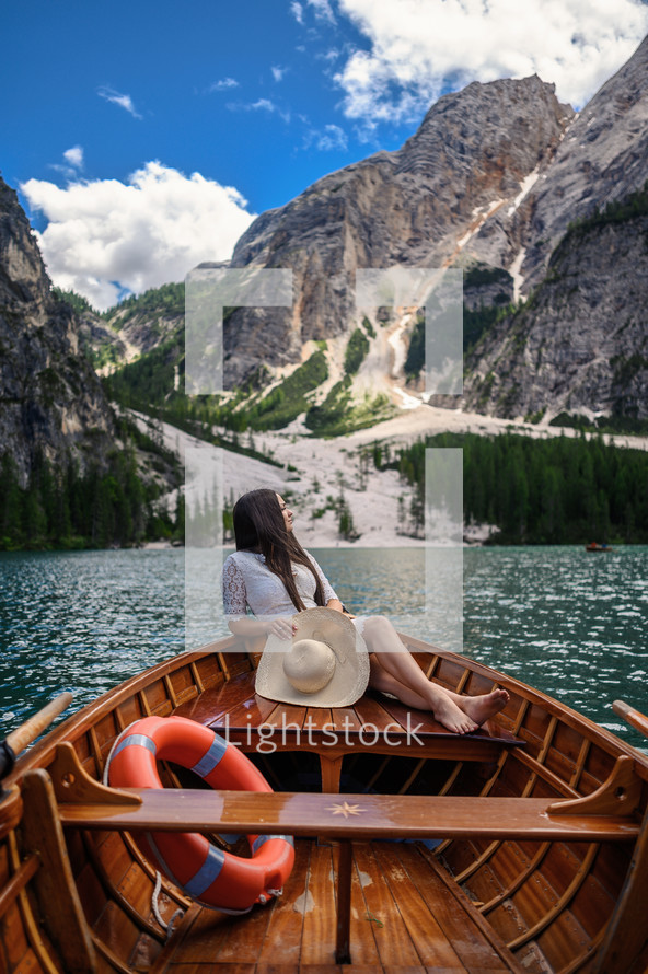 a woman on the stern of a rowboat 