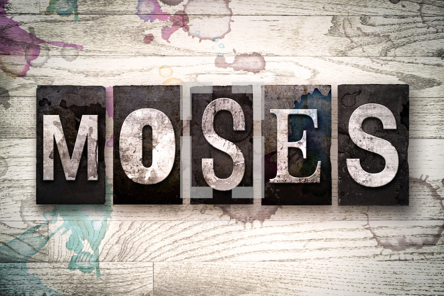 word Moses on white washed wood