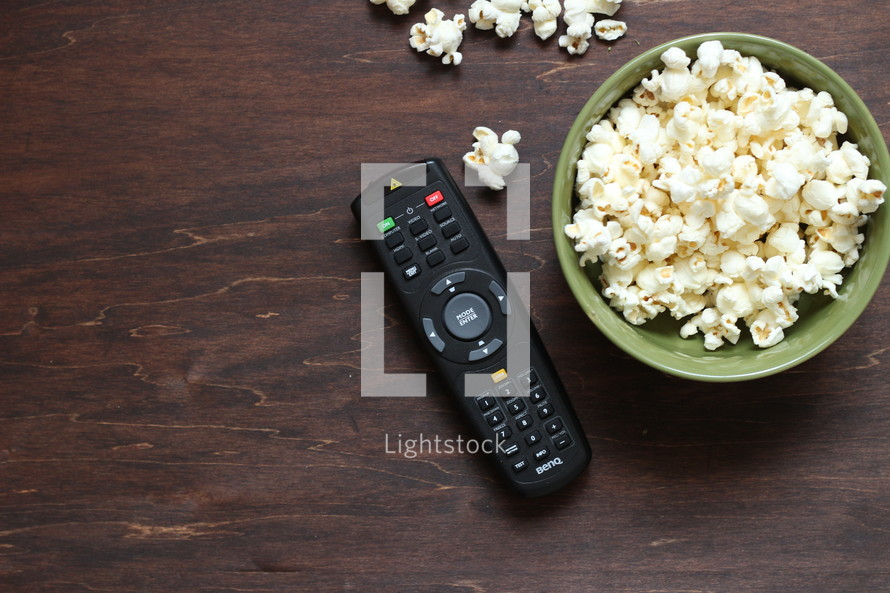 remote control and bowl of popcorn 
