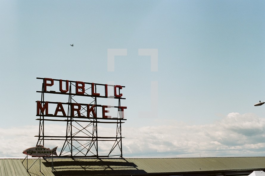Public market sign on top of a building.