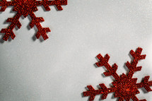 red snowflake ornaments on a red background 
