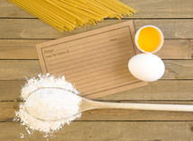 wooden spoon, flour, eggs, and pasta 