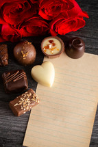 chocolates, roses, and paper for a love letter 