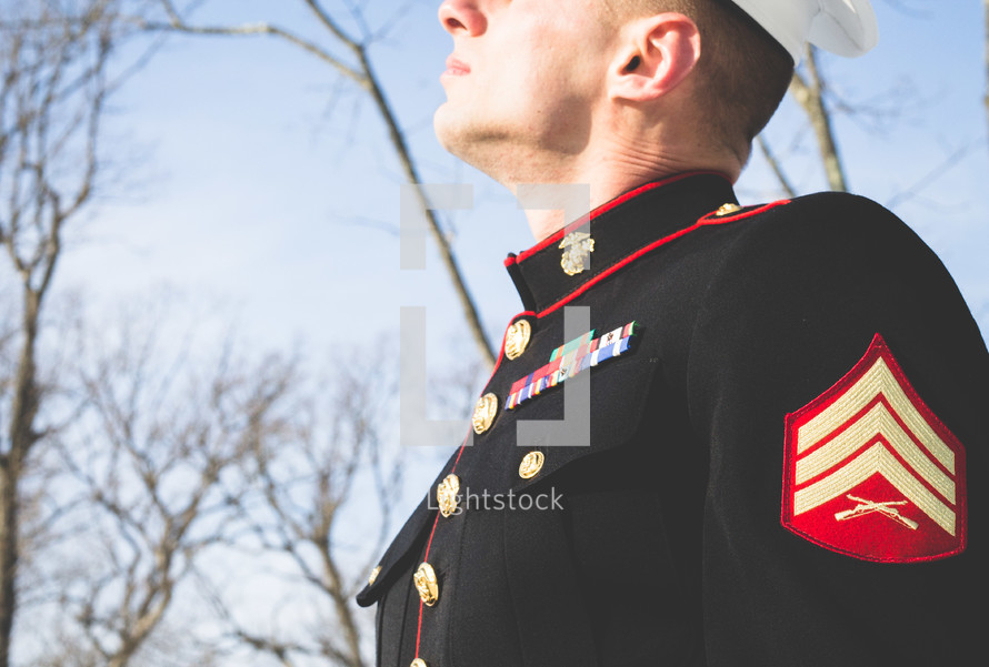 marine in dress blues looking up 