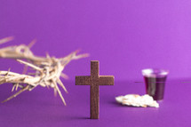 crown of thorns on purple with cross and communion elements 