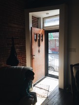 Sunlight shining through an open front door.