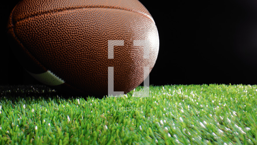 close up of a football ball on the grass