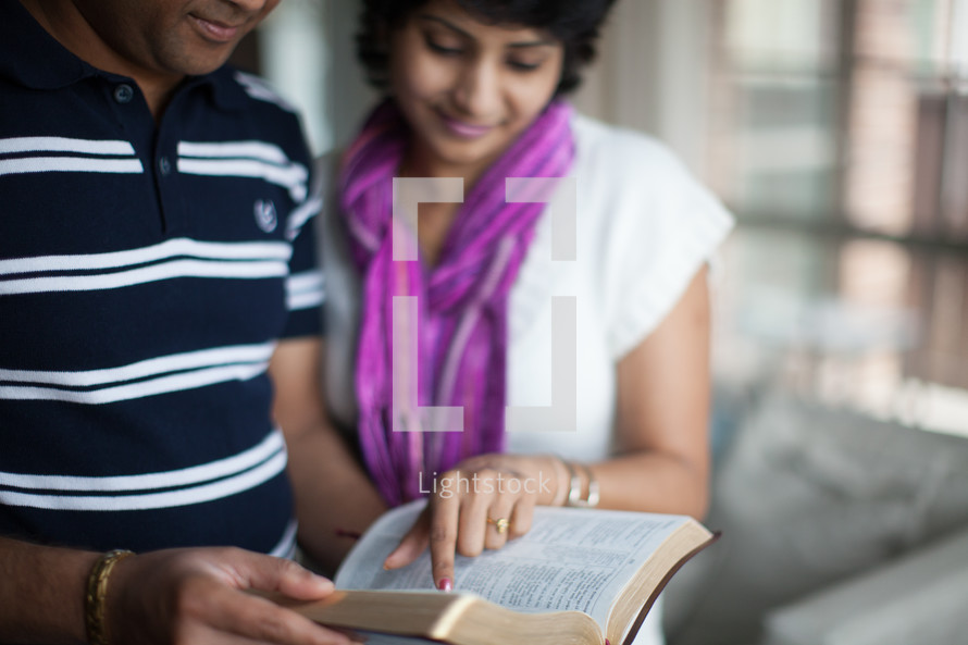 an Indian couple reading a Bible together 