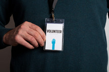 A man wearing a volunteer badge.