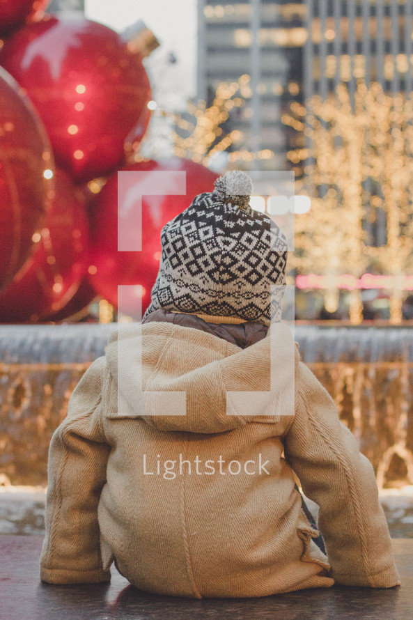toddler boy in a winter coat and hat 