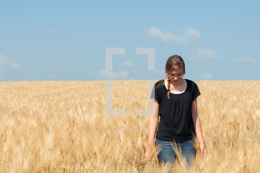 Woman standing in a wheat field.