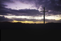 Cross on a hill at daybreak.