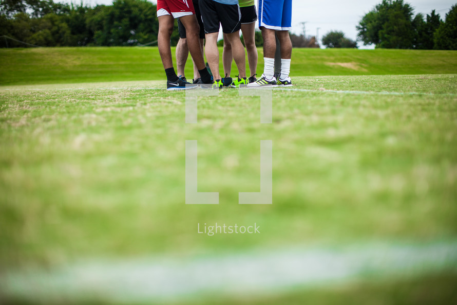 athletes standing on a sports field 