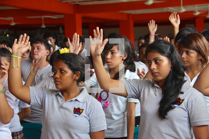 students with raised hands