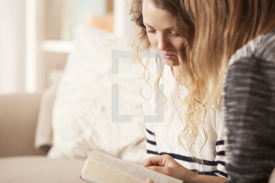 Friends reading a Bible together. 