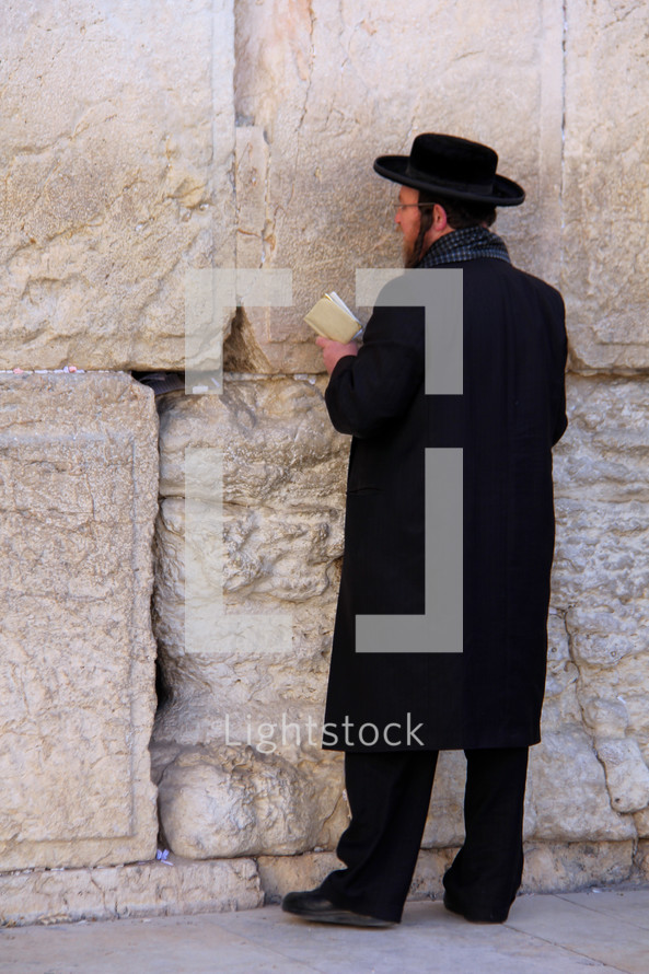 Orthodox Jew worshiping at the Western Wall in Jerusalem.