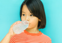 girl drinking from a water bottle 