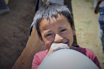 face of a little boy with a balloon 