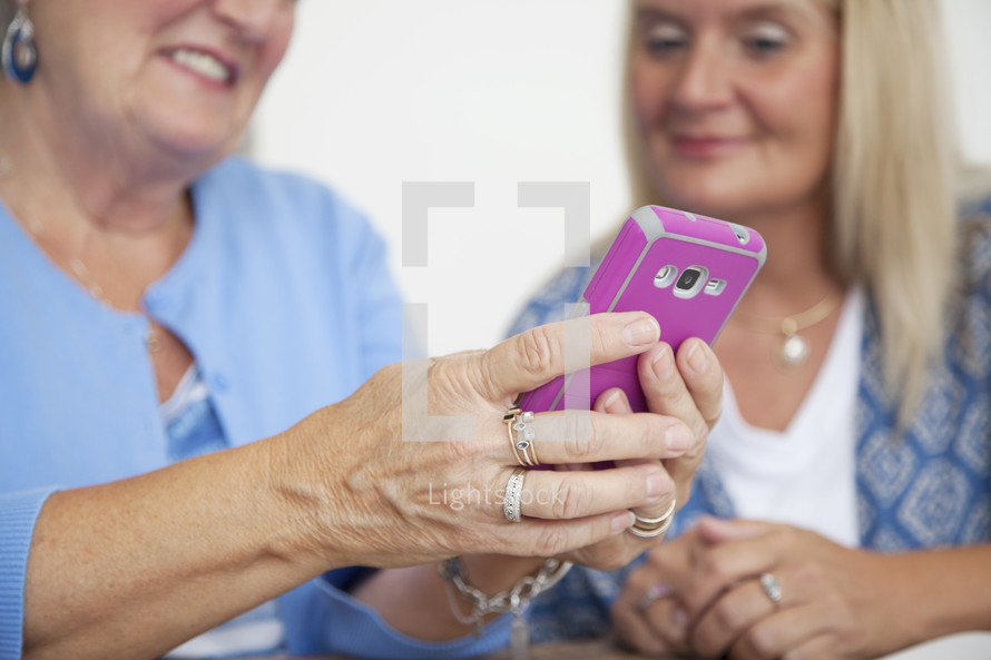 an elderly woman holding a cellphone 