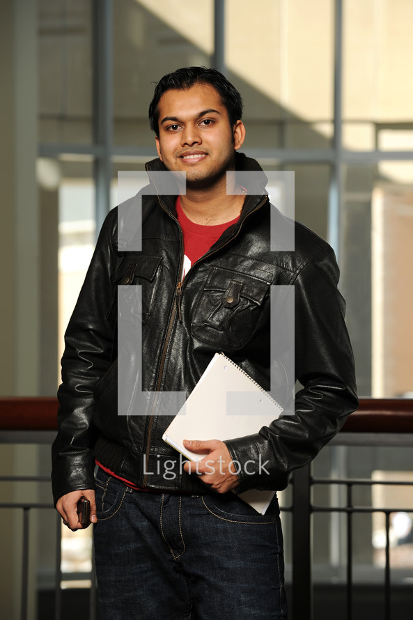 college student holding a notebook 