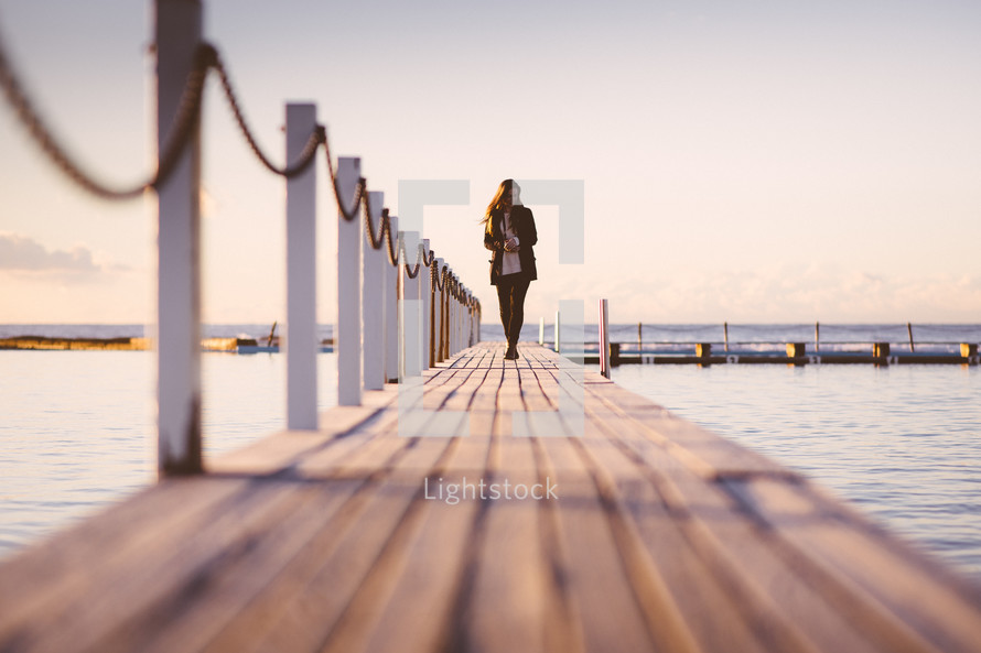 woman walking on a pier 