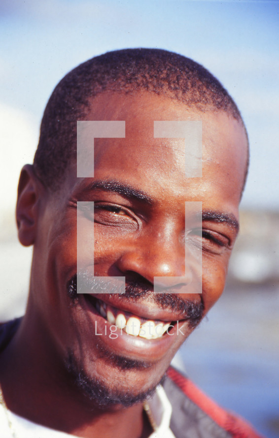 African man with mustache smiling 