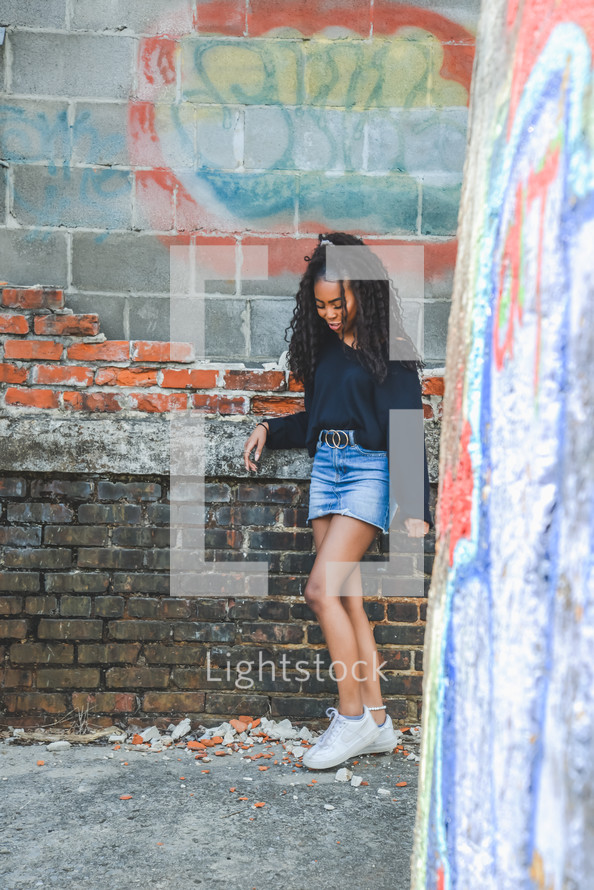 teen girl standing in an alley 