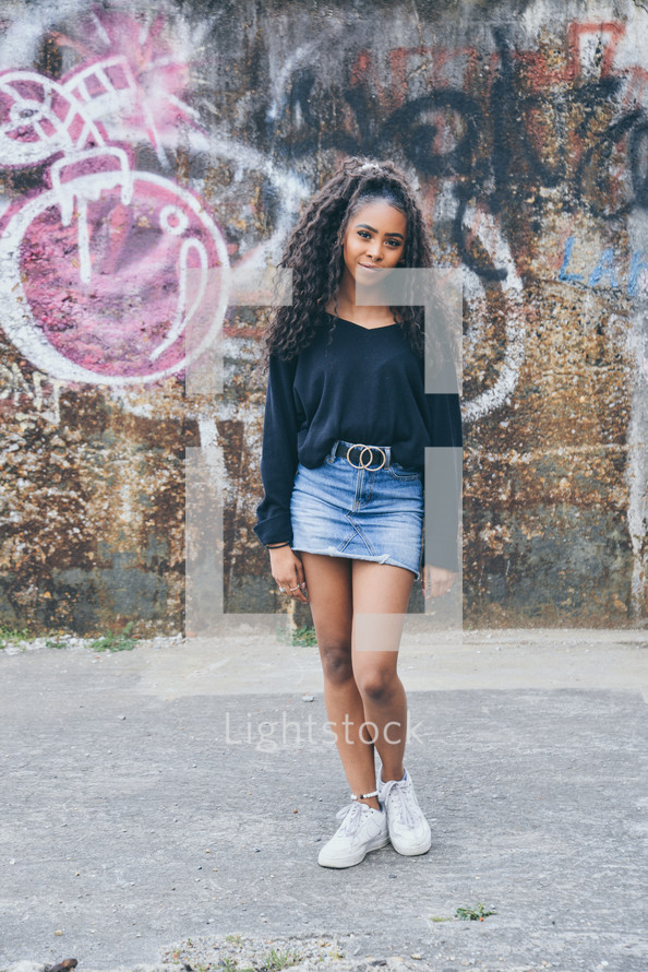 teen girl standing in an alley 