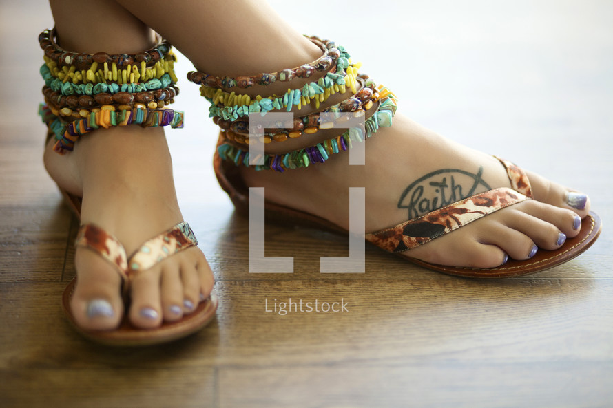 ankle bracelets and flip flops on a woman's feet 