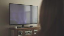 woman watching a worship service from her television 