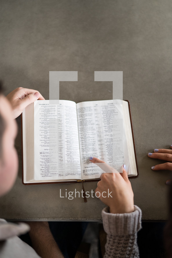 a couple studying a Bible together 