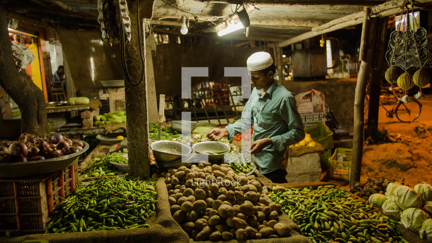 a vendor in a market at night 
