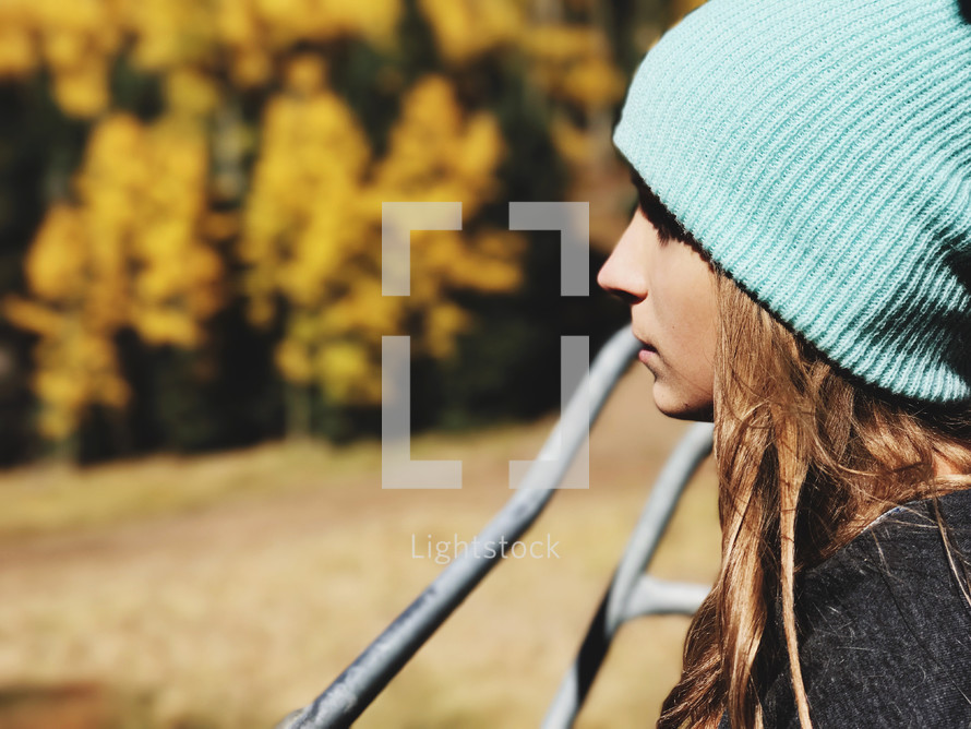 side profile of a teen girl in a wool cap 