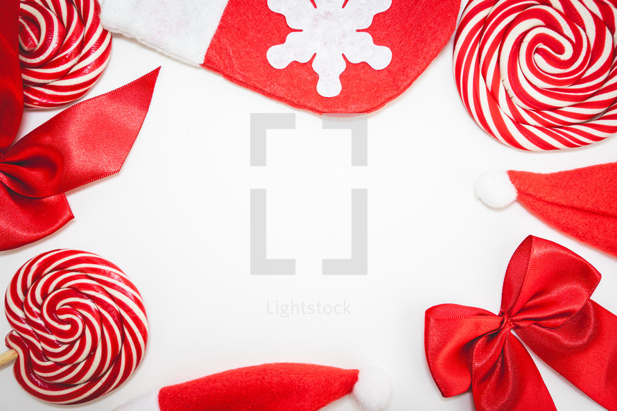 Flatlay of some red Christmas decoration, on a white background. Background for Christmas.