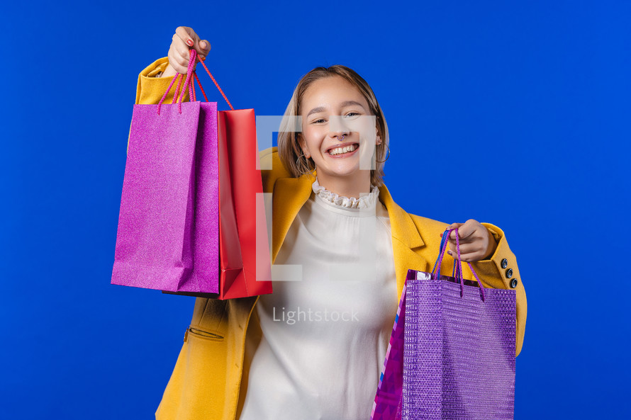 Young girl holding colorful shopping bags