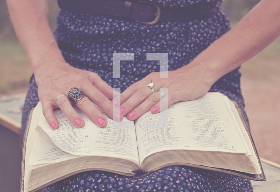 woman reading a Bible on her lap 