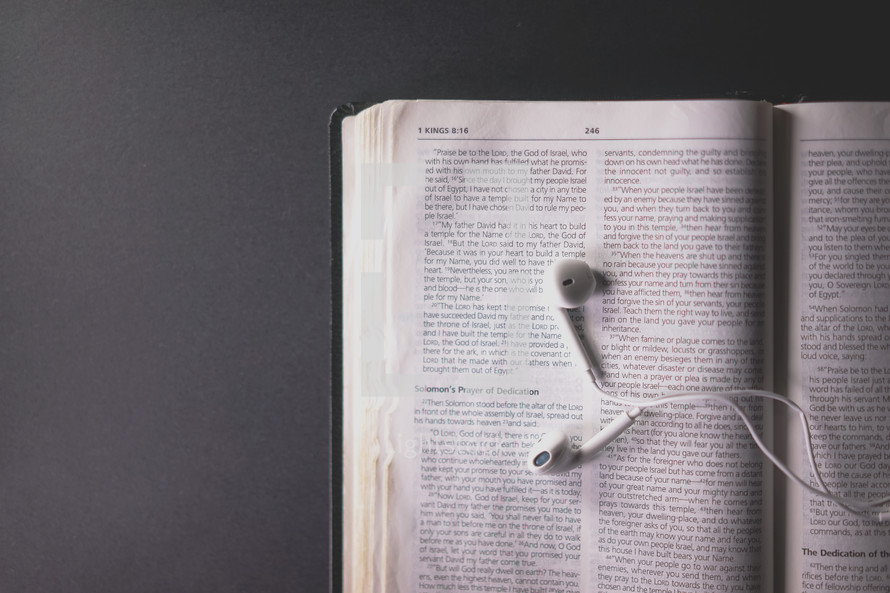 earbuds on the pages of a Bible 