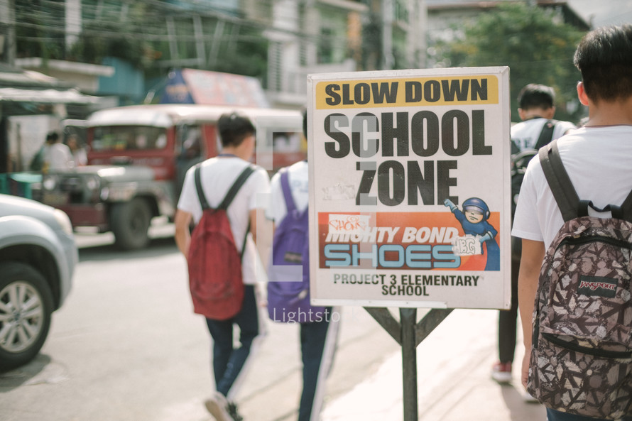 Slow down school zone sign 