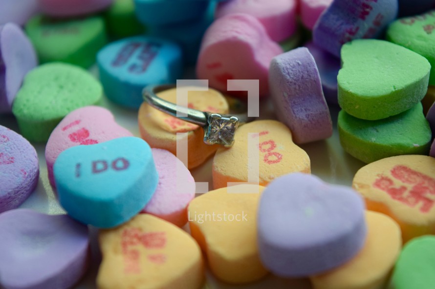 Valentines conversation hearts and diamond engagement ring 