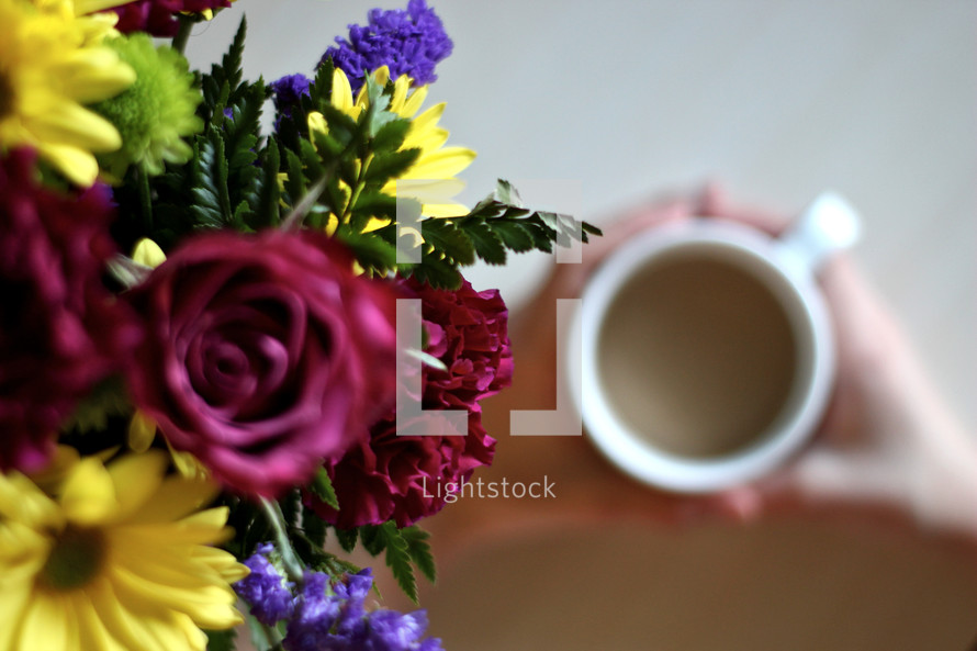 bouquet of flowers and a woman drinking coffee 