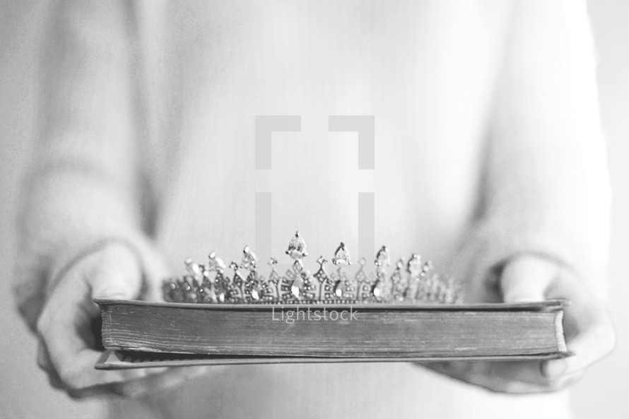 a woman holding a tiara and Bible 