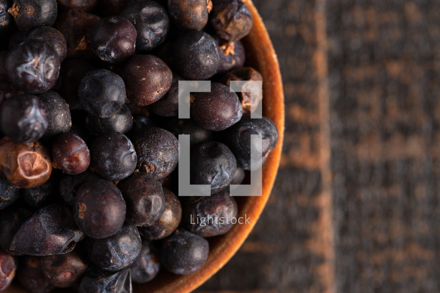 Bowl Full of Dried Juniper Berries on a Wooden Table