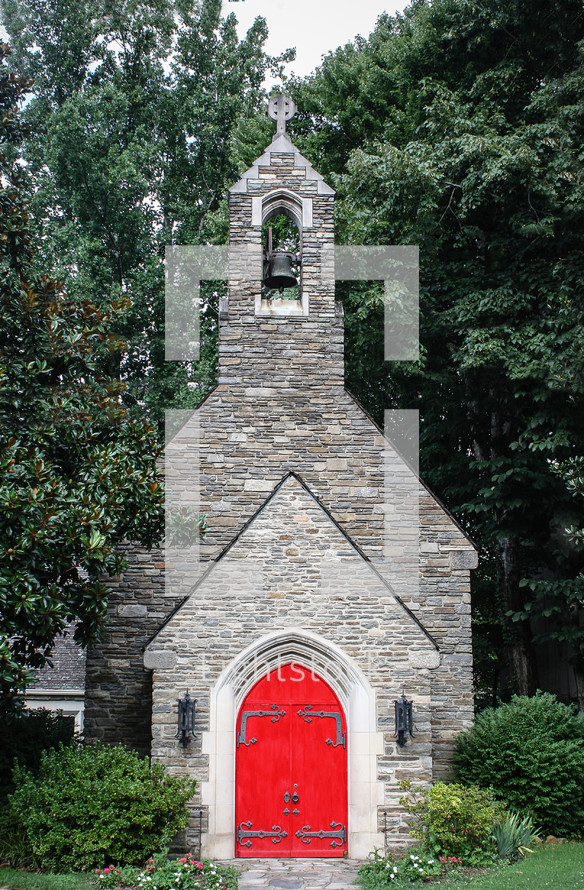 red doors to a stone church 