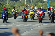 group of motorcyclists on a road 
