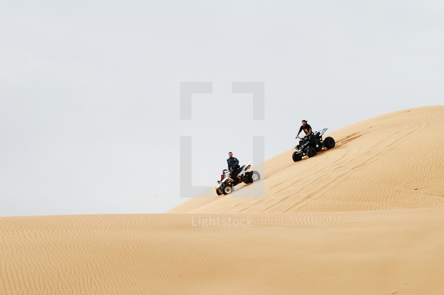 riding ATV's on sand dunes 