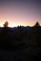 silhouettes of people and mountains 