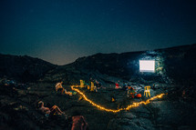 projection screen on a rock at a campsite on a mountain 